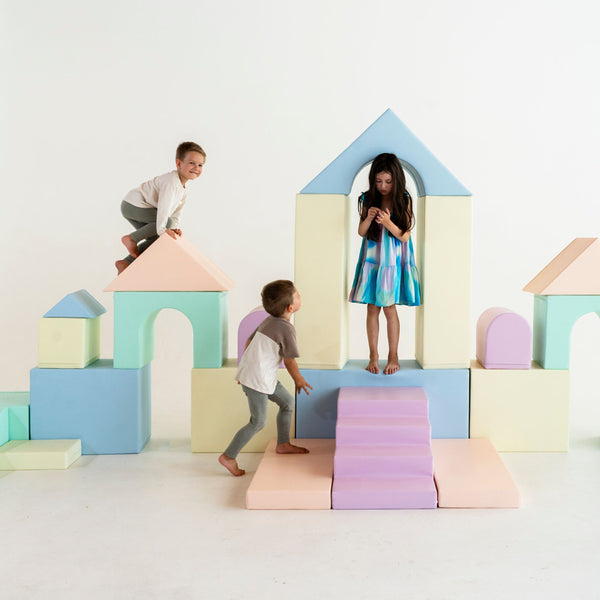 Soft play castle with slide and climbing blocks
