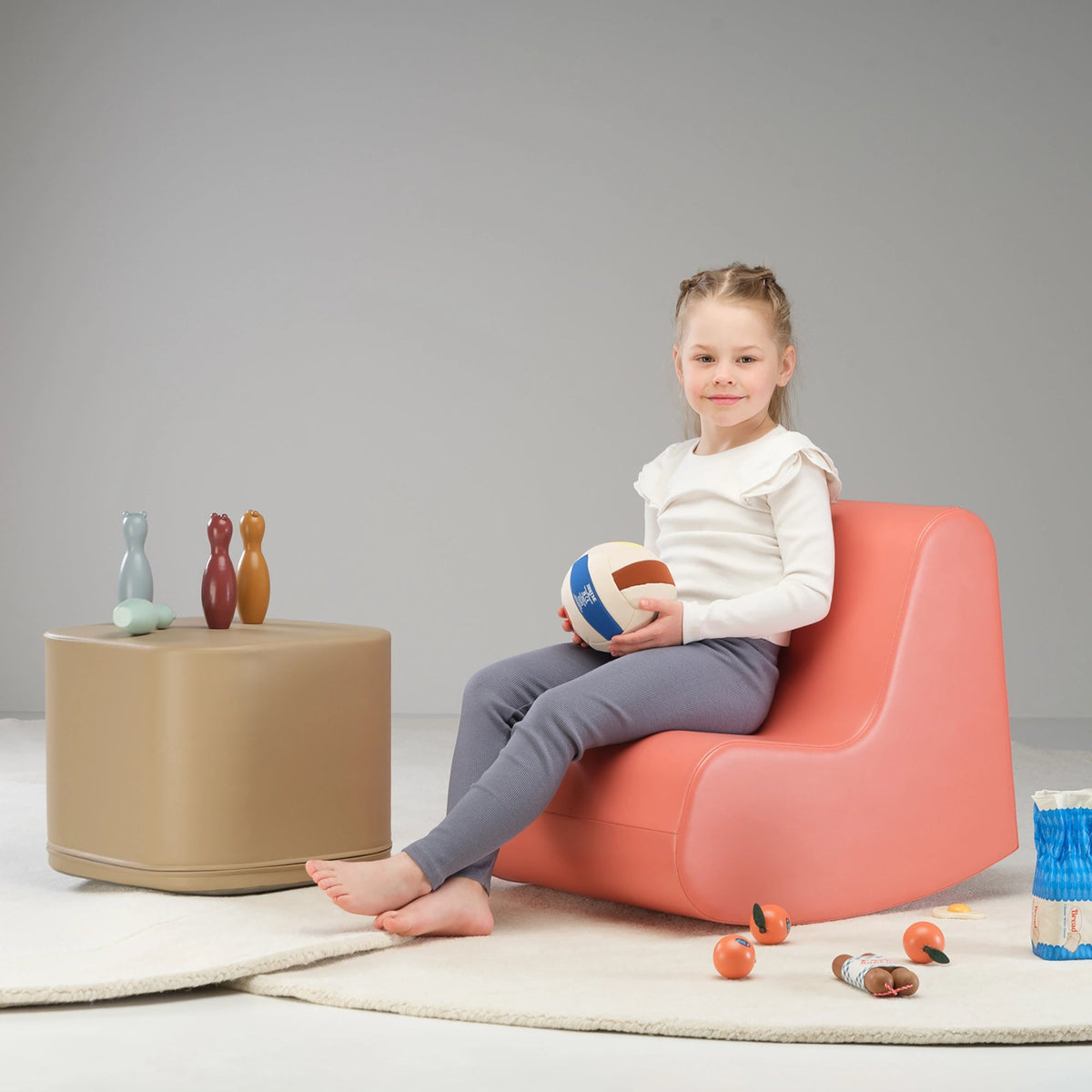 Child relaxing in a soft rocking play chair