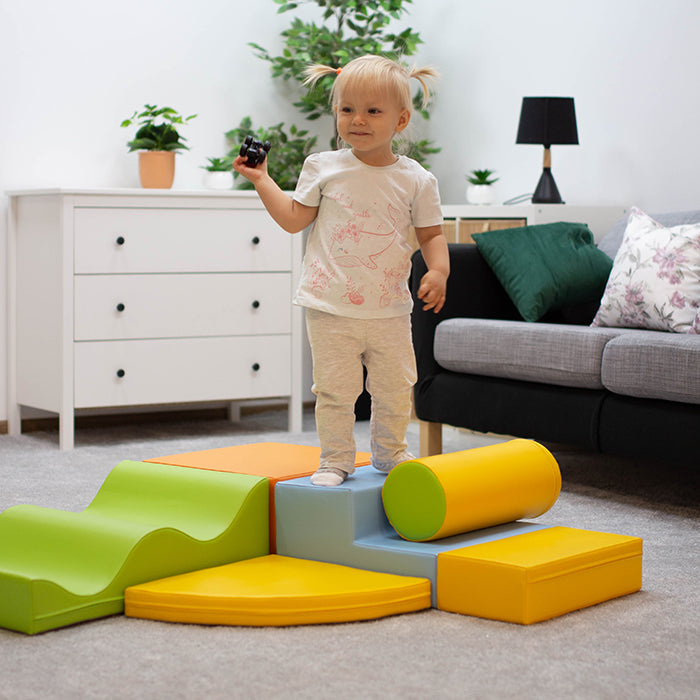 Child playing on soft play discoverer activity set indoors