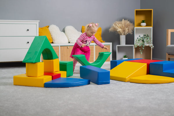 Children playing on a foam soft play set